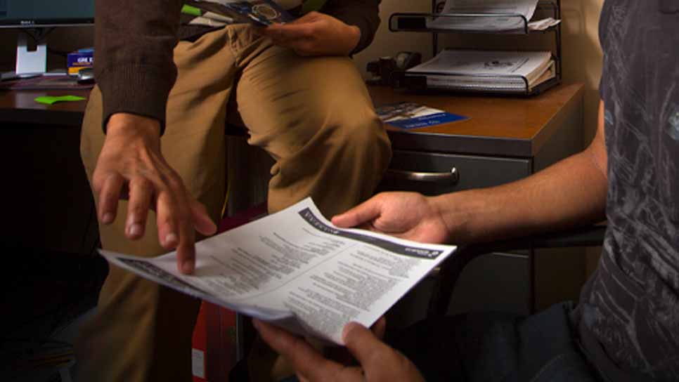 person pointing to informatonal paper