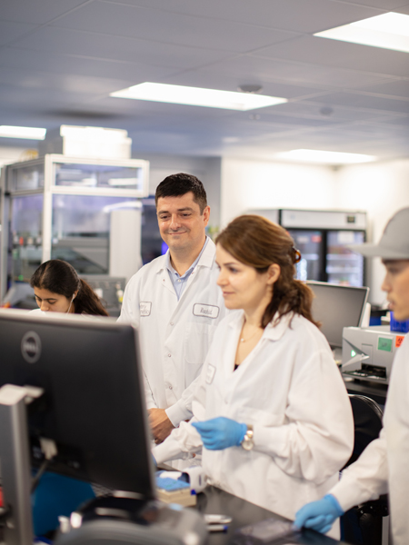 A lab director in the Ambry Genetics lab while overseeing several lab workers