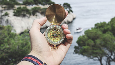 hand holding compass